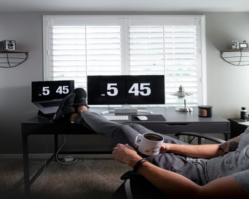 Person taking a break stretching gently next to a home office desk