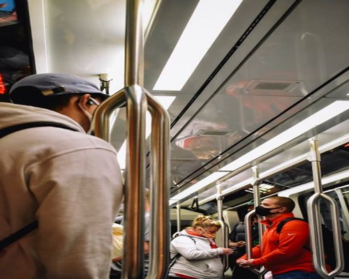People standing comfortably inside a clean public transit train